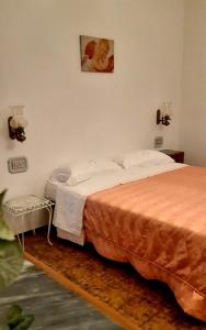 a bedroom with two beds and a picture on the wall at A Casa Di Nonna B&B in Tortoreto Lido