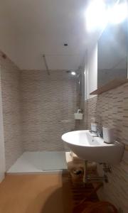 a bathroom with a white sink and a mirror at A Casa Di Nonna B&B in Tortoreto Lido