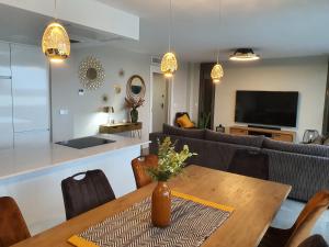 a living room with a table and a couch at Pool & Snooker Villa in Finestrat