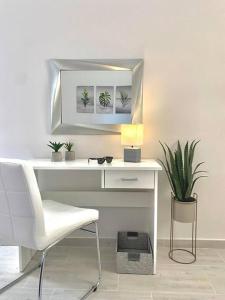 a white desk with a chair and a mirror at Elia Room & Garden II (new entry) in Kontokali