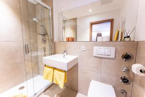 a bathroom with a sink and a shower at Hotel & Chalets Lampllehen in Marktschellenberg