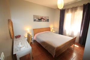 a bedroom with a bed and a table and a window at 33 Avenue Joseph Roumanille in Six-Fours-les-Plages