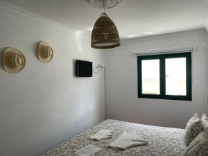 A bed or beds in a room at Pensión Playa