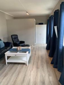 a living room with a couch and a coffee table at Notodden Sentrum Apartment NO 7 in Notodden