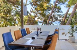 a table and chairs with trees in the background at Hotel Bor in Krk