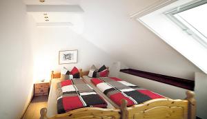 a bedroom with a wooden bed in a attic at Haus Müritz, 14 Roter Milan in Zielow