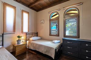 A bed or beds in a room at Selana House with outdoor pool