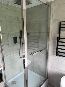 a shower with a glass door in a bathroom at The Fisherbeck in Ambleside
