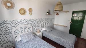 A bed or beds in a room at Pensión Playa