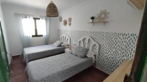 A bed or beds in a room at Pensión Playa
