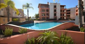 a swimming pool in the middle of a building at Vilamoura Victoria Gardens With Pool by Homing in Vilamoura