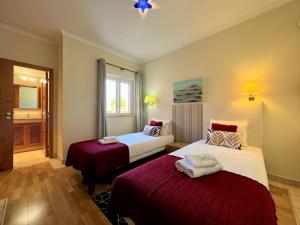 a hotel room with two beds and a window at Vilamoura Victoria Gardens With Pool by Homing in Vilamoura +30 photos