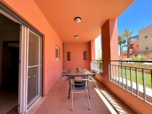 a balcony with a table and chairs on it at Vilamoura Victoria Gardens With Pool by Homing in Vilamoura