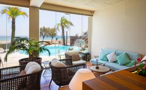 a living room with a view of the ocean at Hotel Maritim in Roses