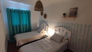 A bed or beds in a room at Pensión Playa
