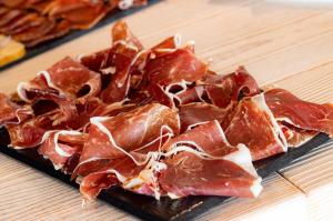 a pile of bacon on a plate on a table at Hotel Maritim in Roses