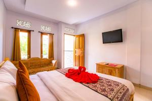 Postel nebo postele na pokoji v ubytování Dede Cottage Ubud