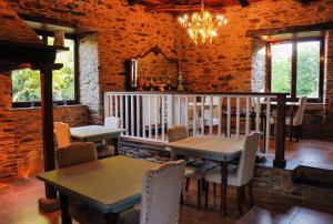 a dining room with tables and chairs in a building at Casa Meiga in Arzúa