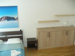 a bedroom with a bed and a wooden cabinet at Garden apartment with garage in central Prague in Prague