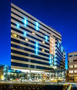 a large building with blue lights on it at Clarion Hotel The Edge in Tromsø
