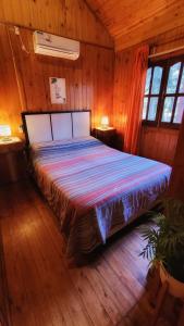 Tempat tidur dalam kamar di Cabañas Pulmahue