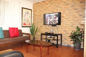 a living room with a couch and a table at Comfy Dwelling in Baguio