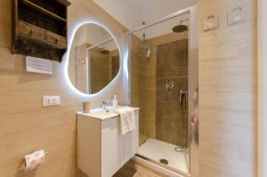 a bathroom with a sink and a shower at JOIVY Apartment Apollo in Rapallo +27 photos