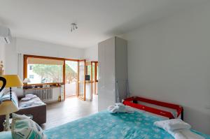 a bedroom with a bed and a living room at JOIVY Apartment Apollo in Rapallo