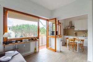 a room with a bed and a kitchen with a table at JOIVY Apartment Apollo in Rapallo