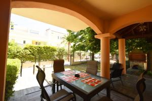 a porch with a table and chairs on a patio at Nena Sea Side Maisonette, Hanioti in Hanioti