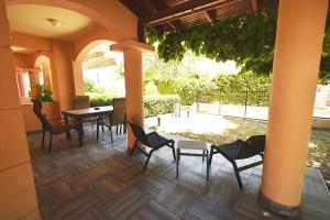 a dining room with chairs and a table and a patio at Nena Sea Side Maisonette, Hanioti in Hanioti