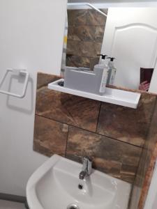 a bathroom with a sink and a mirror at Casa Anhela in Corbu +63 photos