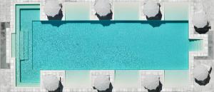 an aerial view of a swimming pool with buildings at Capo Falcone Charming Apartments in Stintino