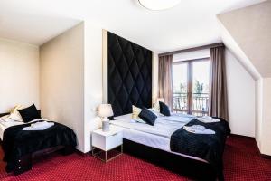 Posteľ alebo postele v izbe v ubytovaní Dworek pod Giewontem - Jacuzzi & Sauna