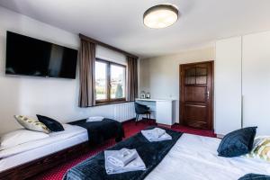 Posteľ alebo postele v izbe v ubytovaní Dworek pod Giewontem - Jacuzzi & Sauna