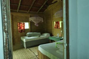 A bed or beds in a room at Wild Planet Eco Retreat