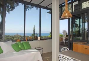 a bedroom with a bed and a view of the ocean at Villa ALFONSA in Saint-Raphaël