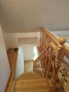 a wooden staircase in a house with wooden floors at Red Nose roof-top apartment in Rīga