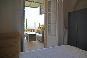 a bedroom with a door leading to a living room at Villa ALFONSA in Saint-Raphaël