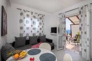 a living room with a couch and a table at Apartments Babic in Milna