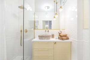 a bathroom with a sink and a shower at apart76 Gdańsk Bastion Wałowa in Gdańsk