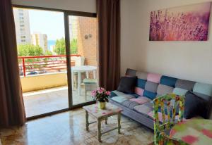 a living room with a couch and a table at Apartments Carlos V in Benidorm