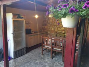 a kitchen with a table and a pot of flowers at C Dor de Vama Bedrooms in Vama Veche