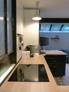 an office with a desk with a sink and a window at 51 côté jardin in Selvigny