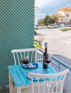 a table with two glasses of wine on a balcony at Dantel Butik Ev Pansiyon in Kas