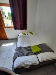 a small bed in a room with a window at Apartment Klementina FREE PARKING in Zagreb