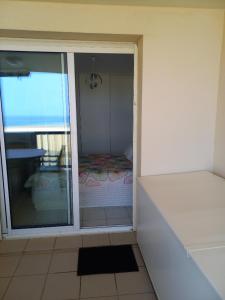 an open door to a room with a view of a patio at Les Goélands de l'Océan in Vieux-Boucau-les-Bains