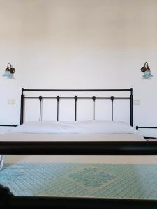 a bedroom with a bed with a black metal frame at B&B Tre in Oristano