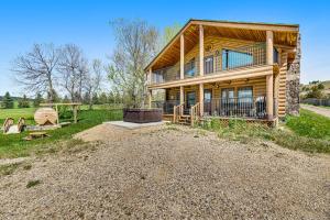 a large house on a dirt road with a yard at Waterwheel Retreat in Sturgis