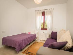 a bedroom with a bed and a couch and a window at Villa HEIDI in Málaga +6 photos